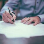 man-writing-on-paper